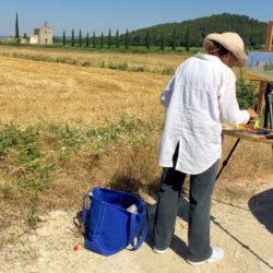 Kelly painting French chapel across a field