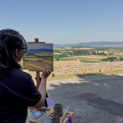 Marissa painting view from hill town of Chateauneuf de Mazenc