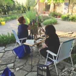 Gail and Hiroko painting in courtyard of B & B